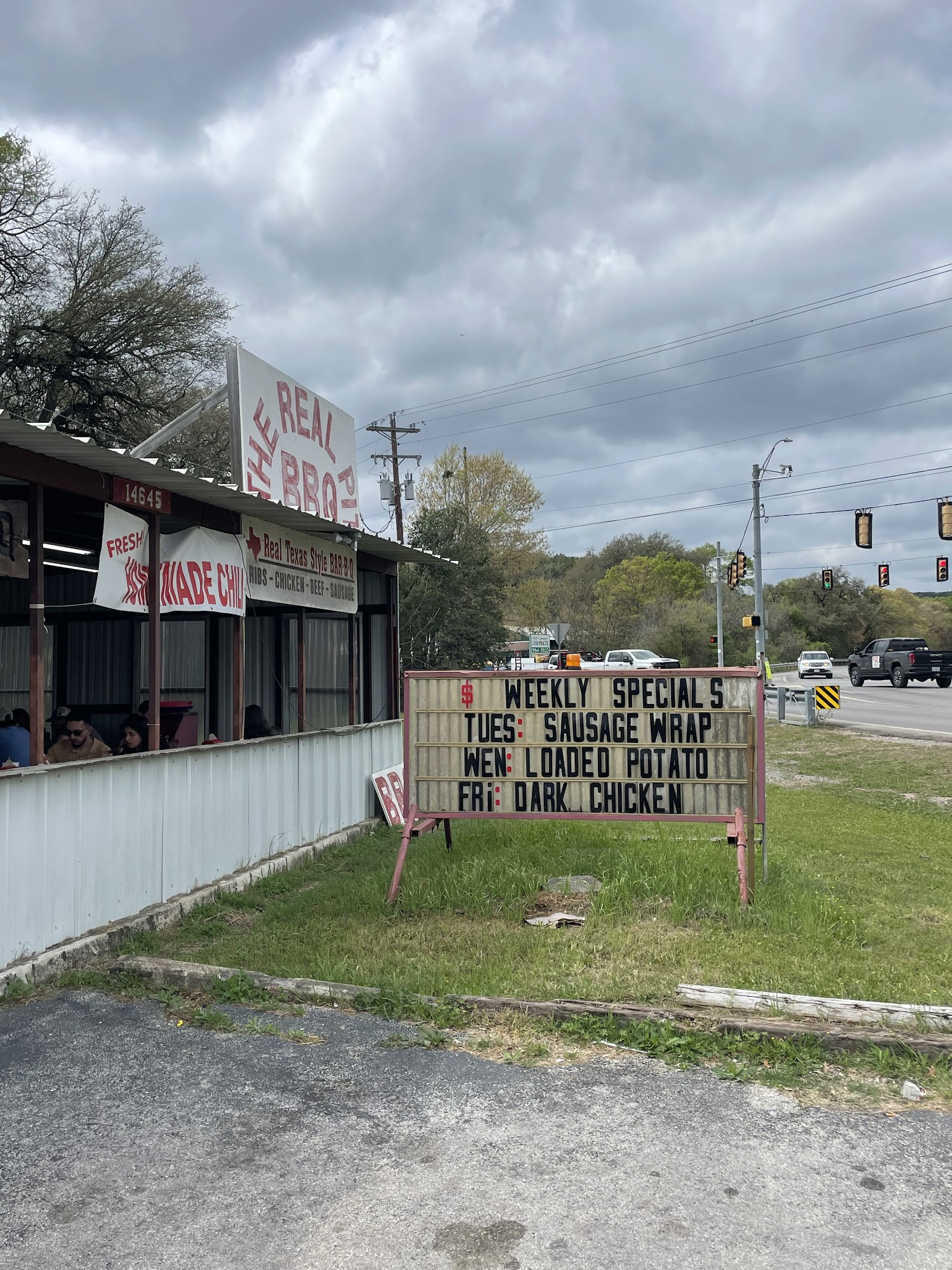 The Real Pit BBQ roadside sign and covered dining porch